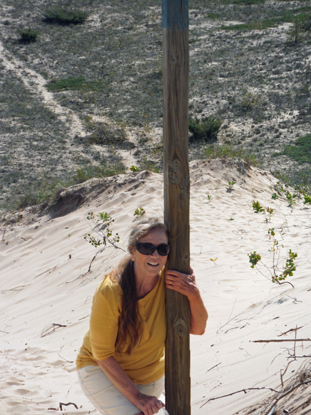 Karen Duquette clings to a pole
